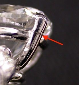 close up of crack in engagement ring claw