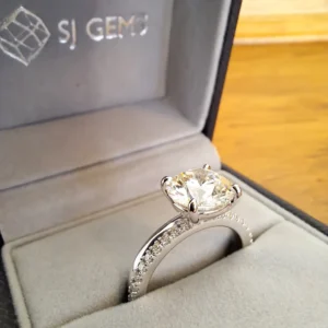 Diamond ring in a grey jewellery box.