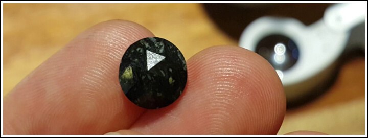 natural black diamond stone on index fingers